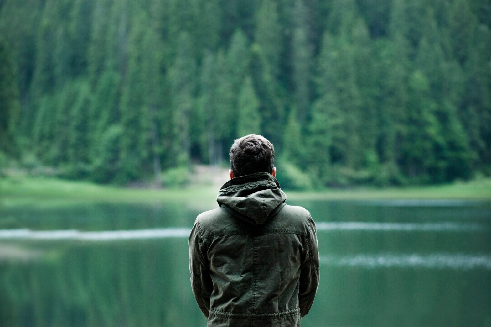 Man sitting by lake