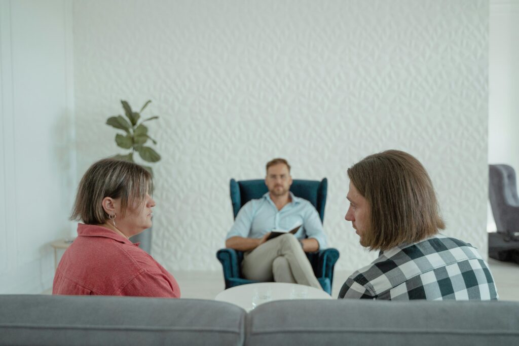 Marital counselling session with therapist helping couple communicate